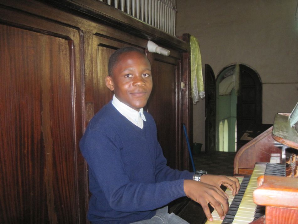 Boy playing organ at cathedral